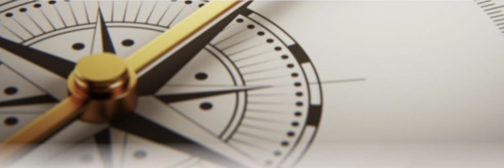 Close-up of a compass rose with a gold needle